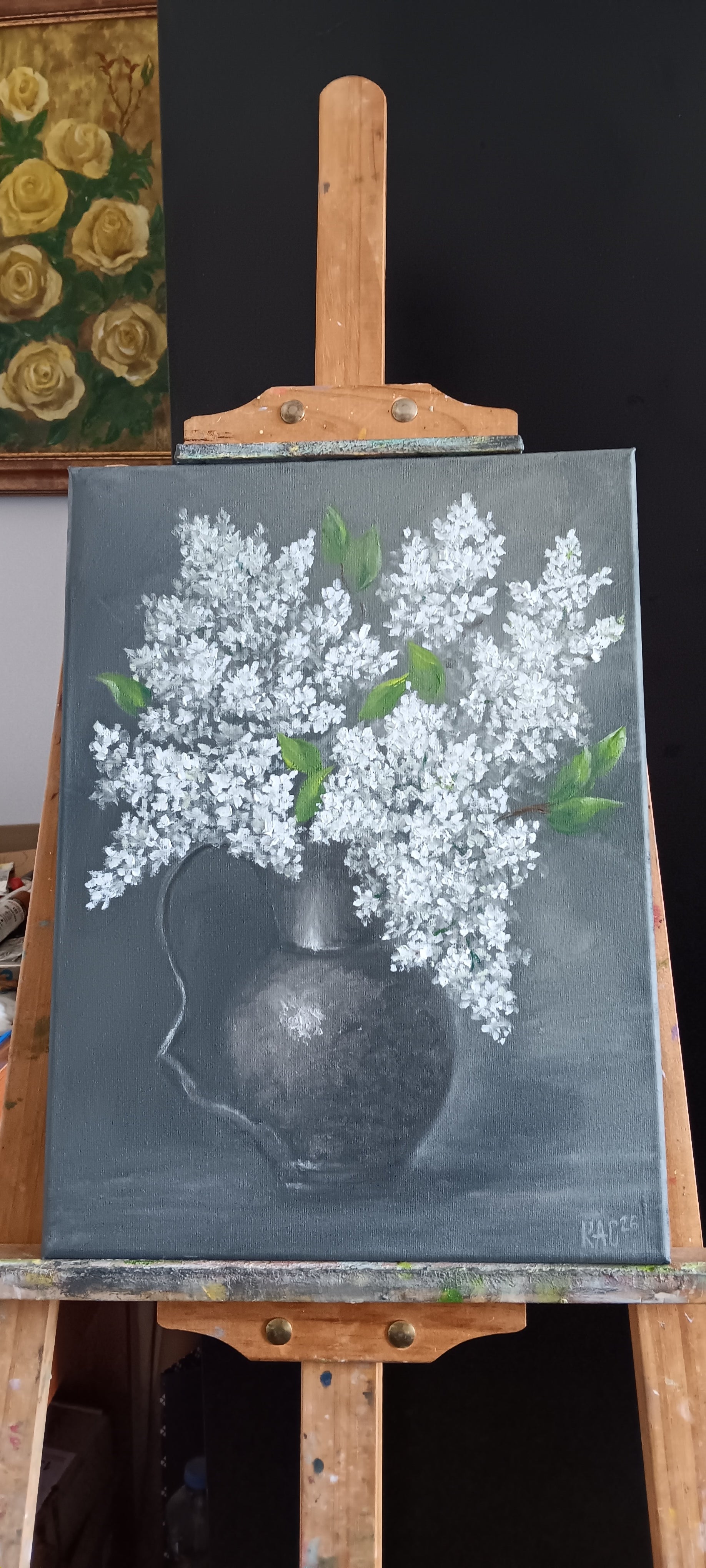 Original oil painting of a lush bouquet of white lilacs in a dark metallic pitcher against a moody grey background, 30x40 cm, signed by the artist.